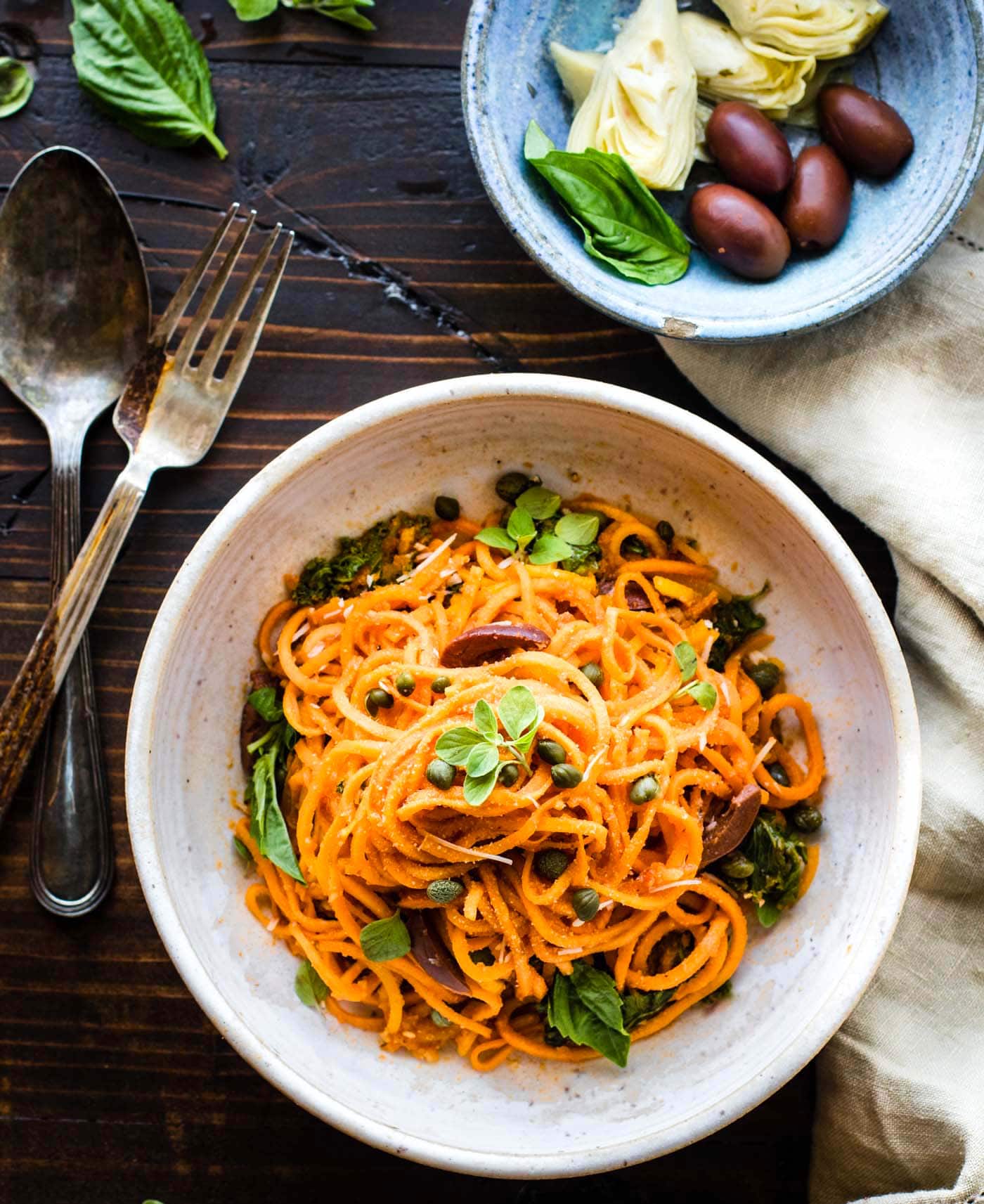 spiralized sweet potato pasta with meatless tomato sauce and capers