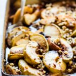 pan of baked apple slices in caramel syrup