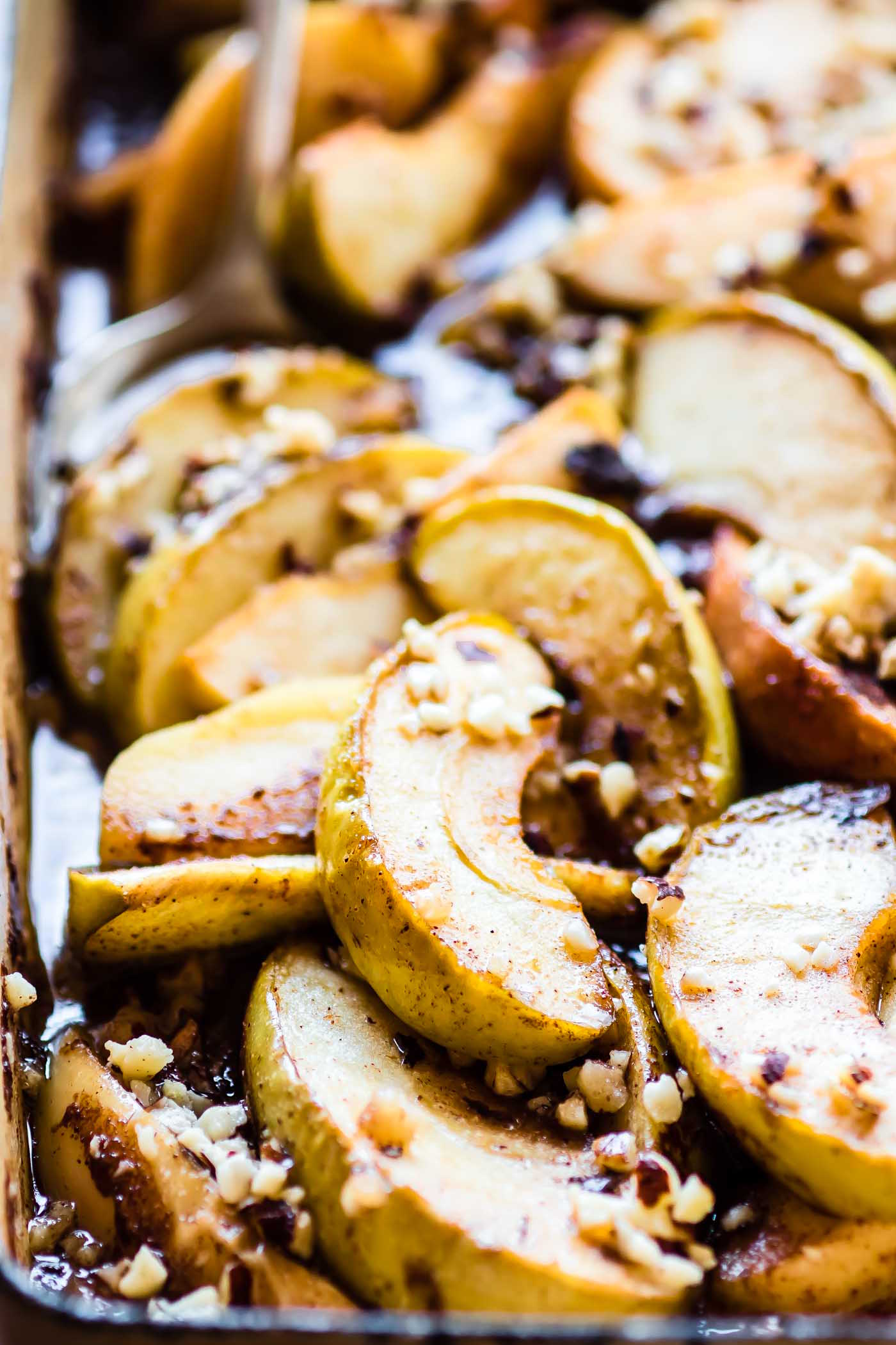 pan of baked apple slices in caramel syrup