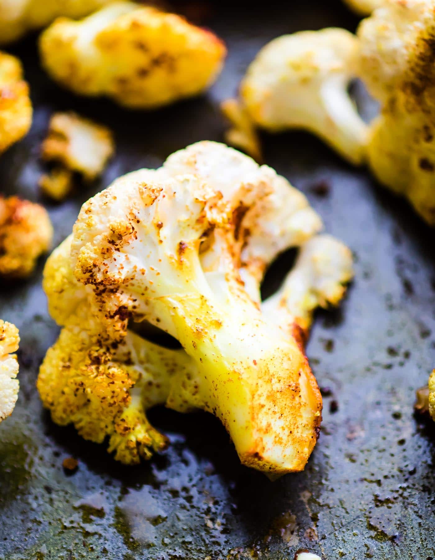 close up of roasted cauliflower florets with curry seasoning