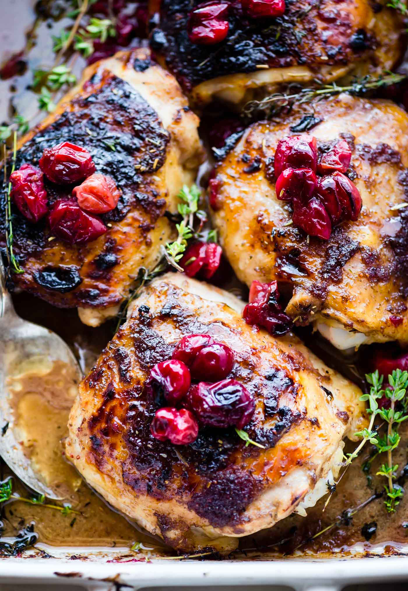 overhead photo: Balsamic Roasted Chicken topped with Cranberries, cooked on baking sheet