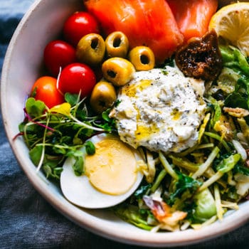 warm salad with smoked salmon, green olives, egg and whipped goat cheese