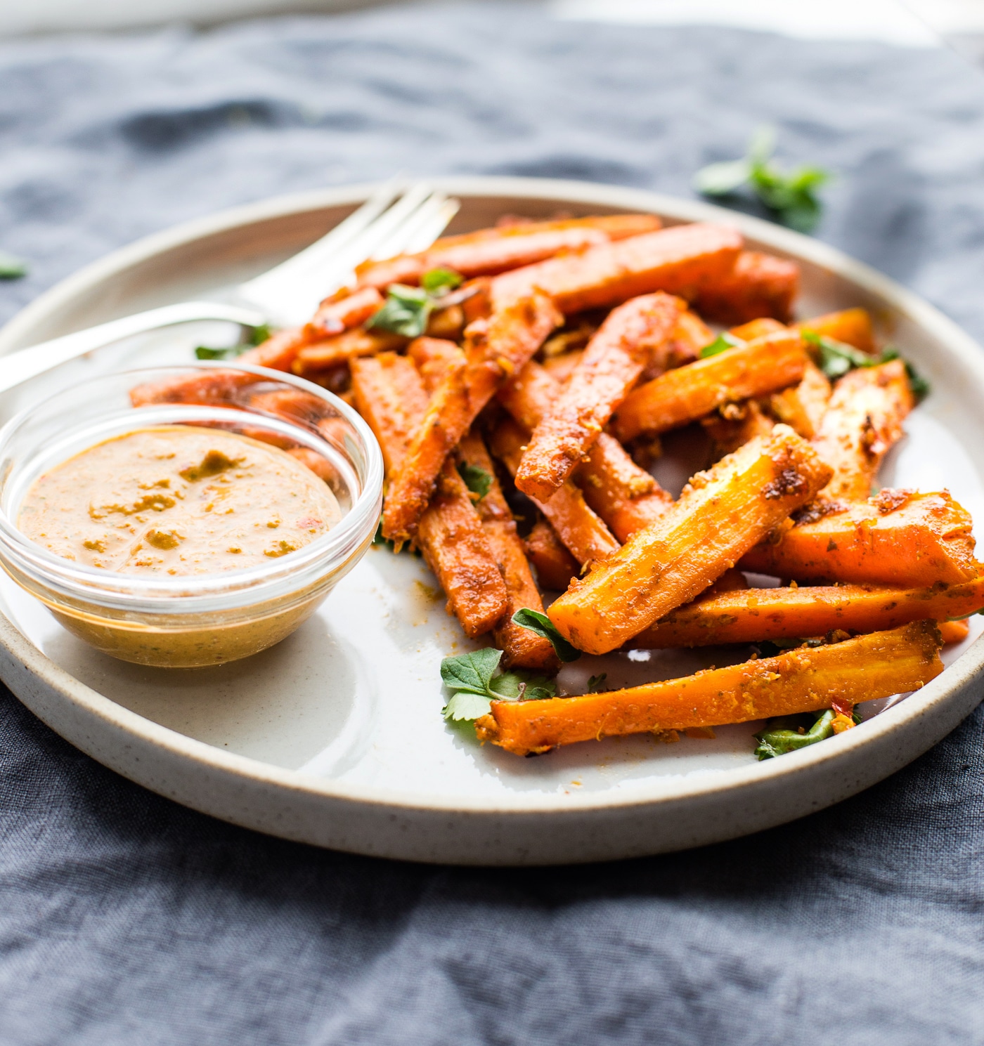 Oven baked carrot fries cooked in a homemade Peri Peri Sauce. Flavorful Crispy carrot fries that make an easy paleo appetizer. Vegan, whole 30 friendly.
