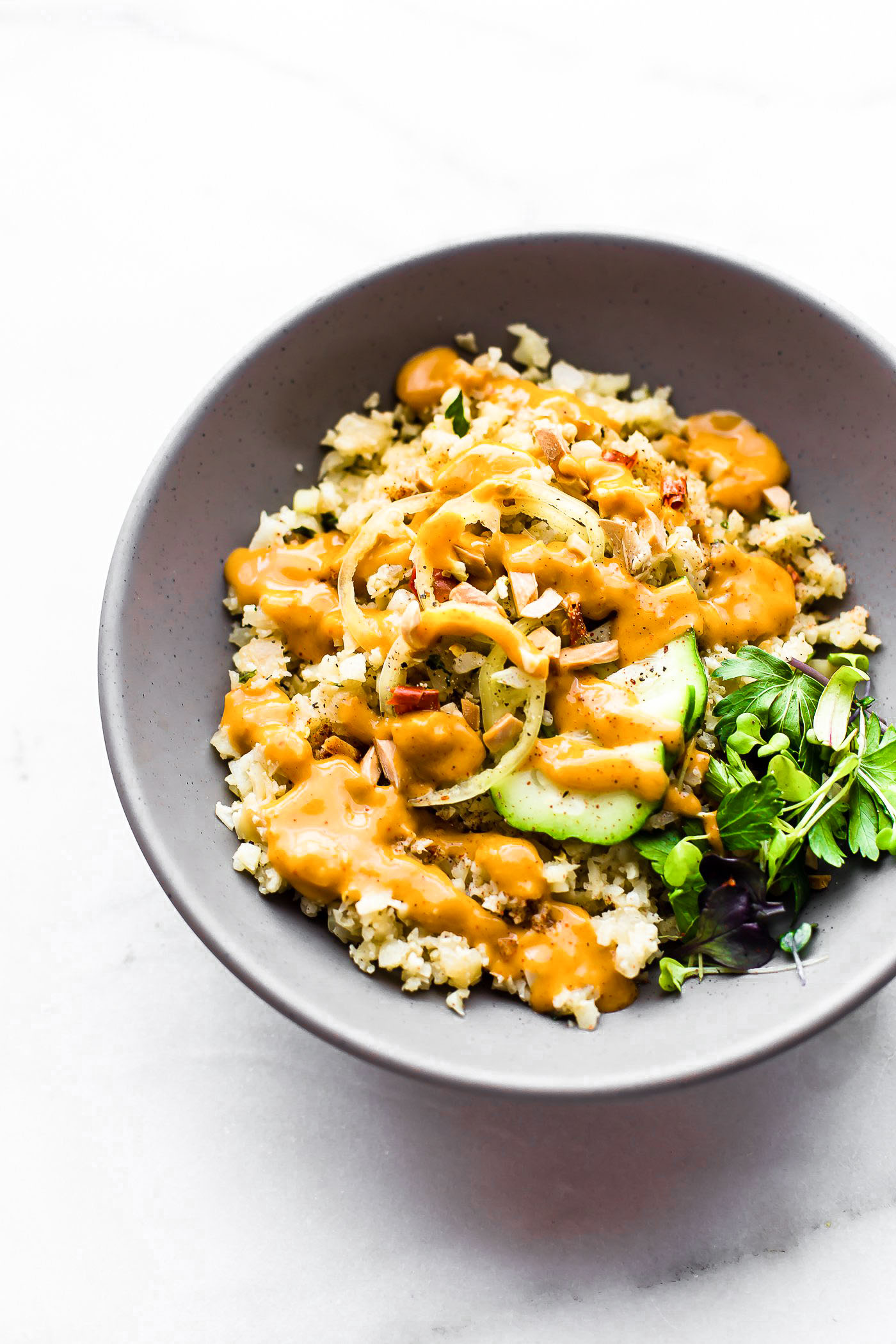 Chili Garlic Cauliflower Risotto Bowls are an easy Paleo dish to satisfy that comfort food craving! A healthy vegan recipe with a spicy sauce. #paleo #vegan #cauliflower #dinner #healthy #dairyfree #risotto