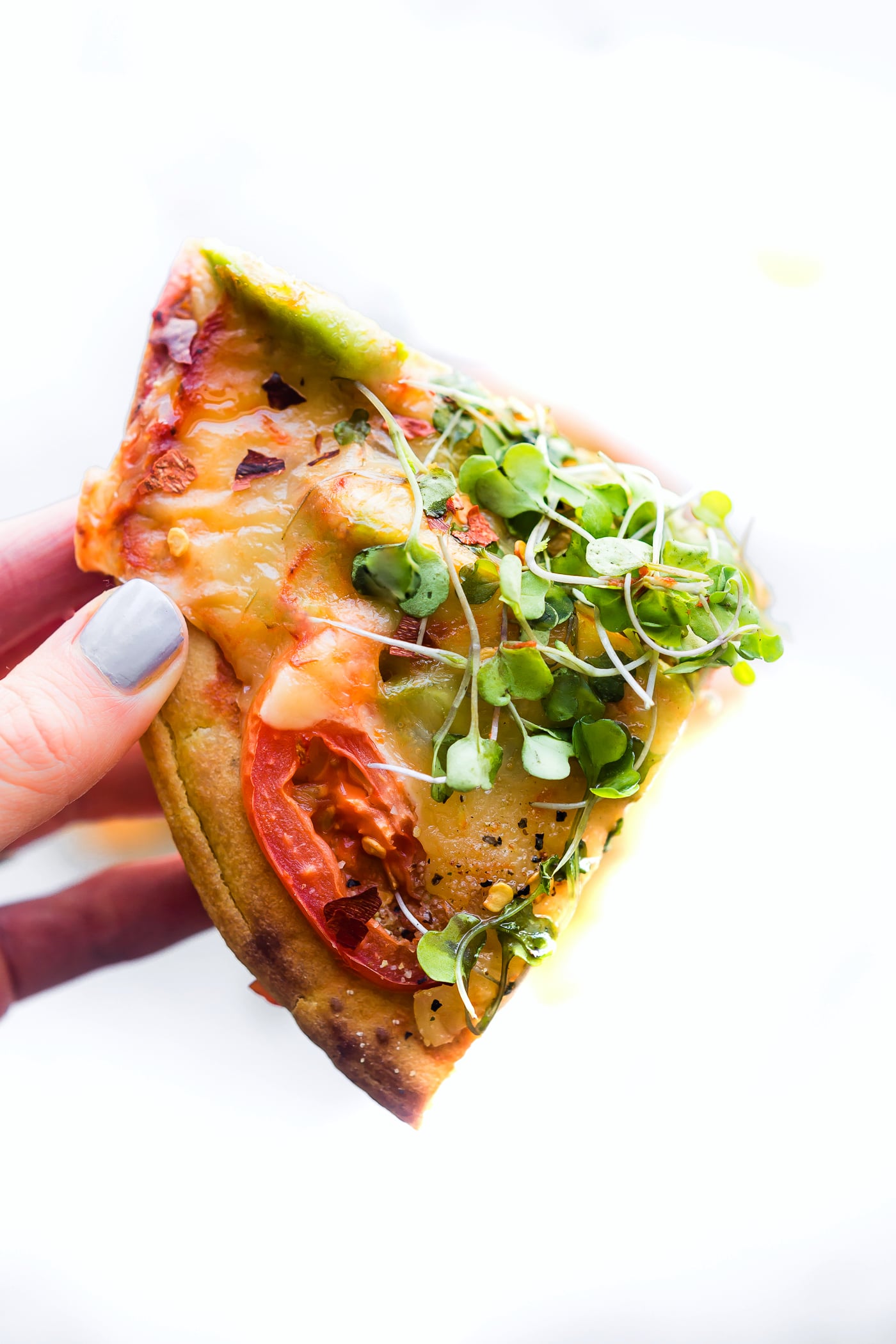 Avocado Tomato Gouda Socca Pizza recipe to love! A grain free, gluten free Avocado Tomato Gouda Socca Pizza made with chickpea flour and topped with Avocado, Gouda, Tomato, and Sprouted Greens! Seriously easy to make, egg free, vegan option, OMG delicious!