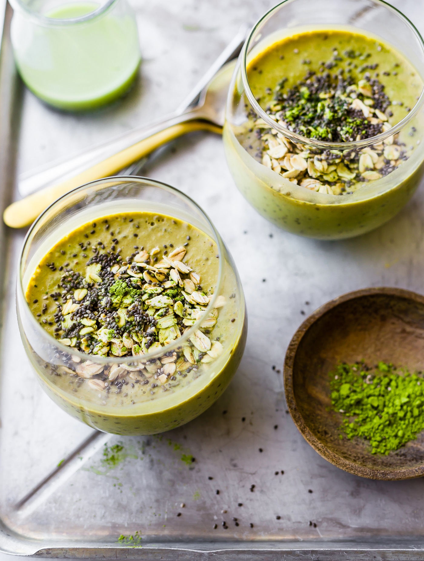 2 glasses with make ahead breakfast drinks made with matcha powder, chia seeds, and coconut yogurt