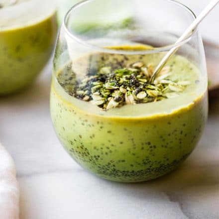 chia matcha smoothie topped with chia seeds in short drinking glass