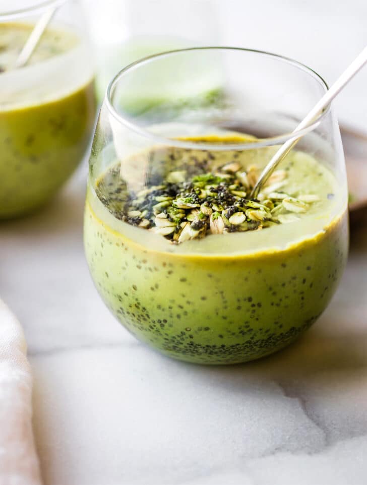 chia matcha smoothie topped with chia seeds in short drinking glass