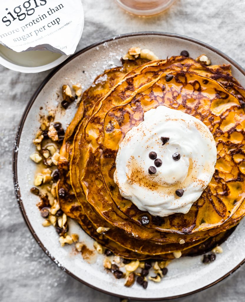 Flourless Carrot Cake Yogurt Pancakes recipe that’s perfect for breakfast or brunch. These Flourless Carrot "Cake" Yogurt Pancakes are too good to be true! Made with siggi’s vanilla yogurt, making them lower in sugar, gluten free, and protein packed! An easy blender recipe. #siggisdairy 