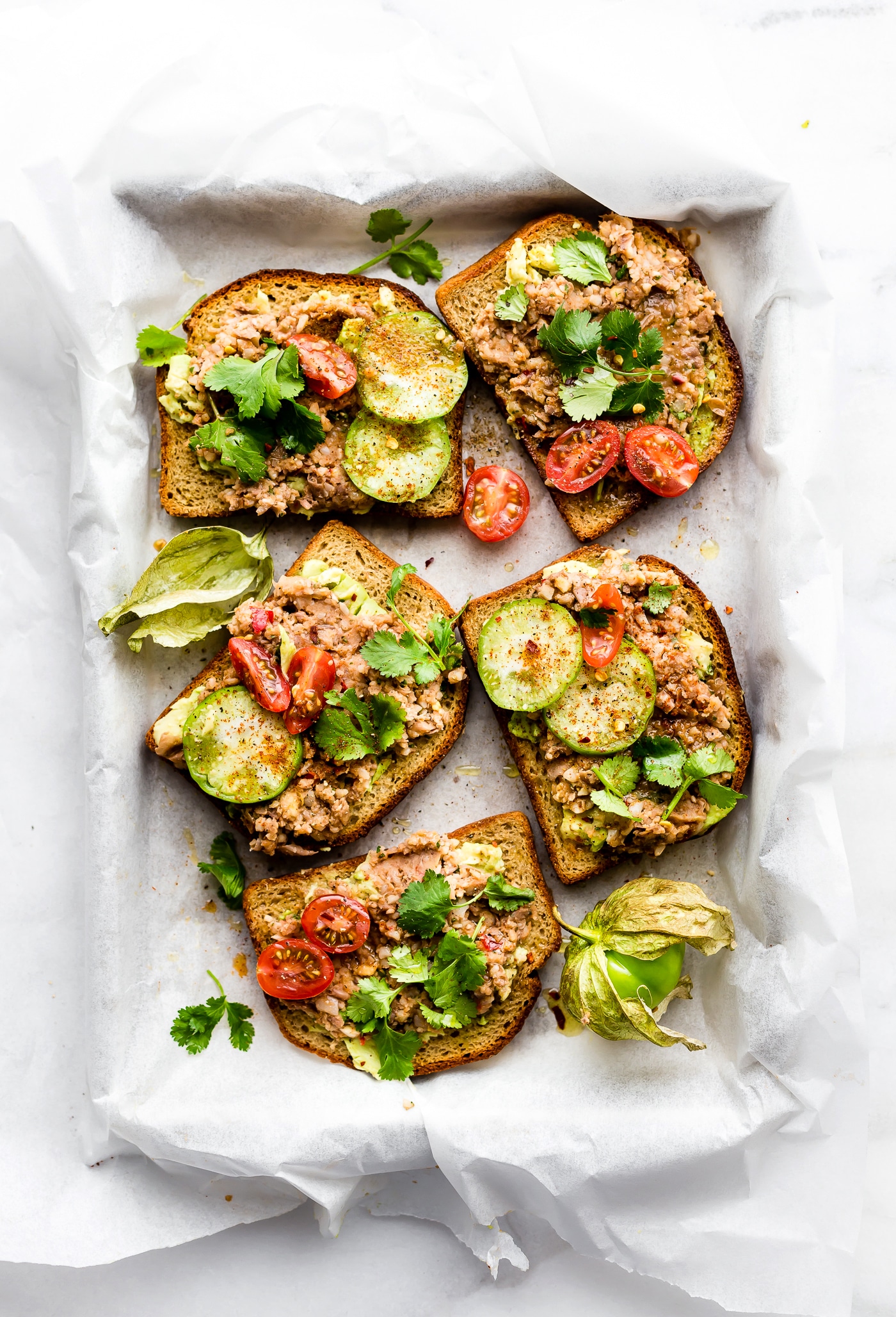 Smashed Mexican Beans Avocado Toast! Avocado Toast Recipes need a little upgrade. This Fully Loaded MEXICAN style avocado toast recipe is Gluten Free, Vegan Friendly loaded with Flavor!! A simple, yet spicy, meatless meal, breakfast, or even a healthy appetizer.