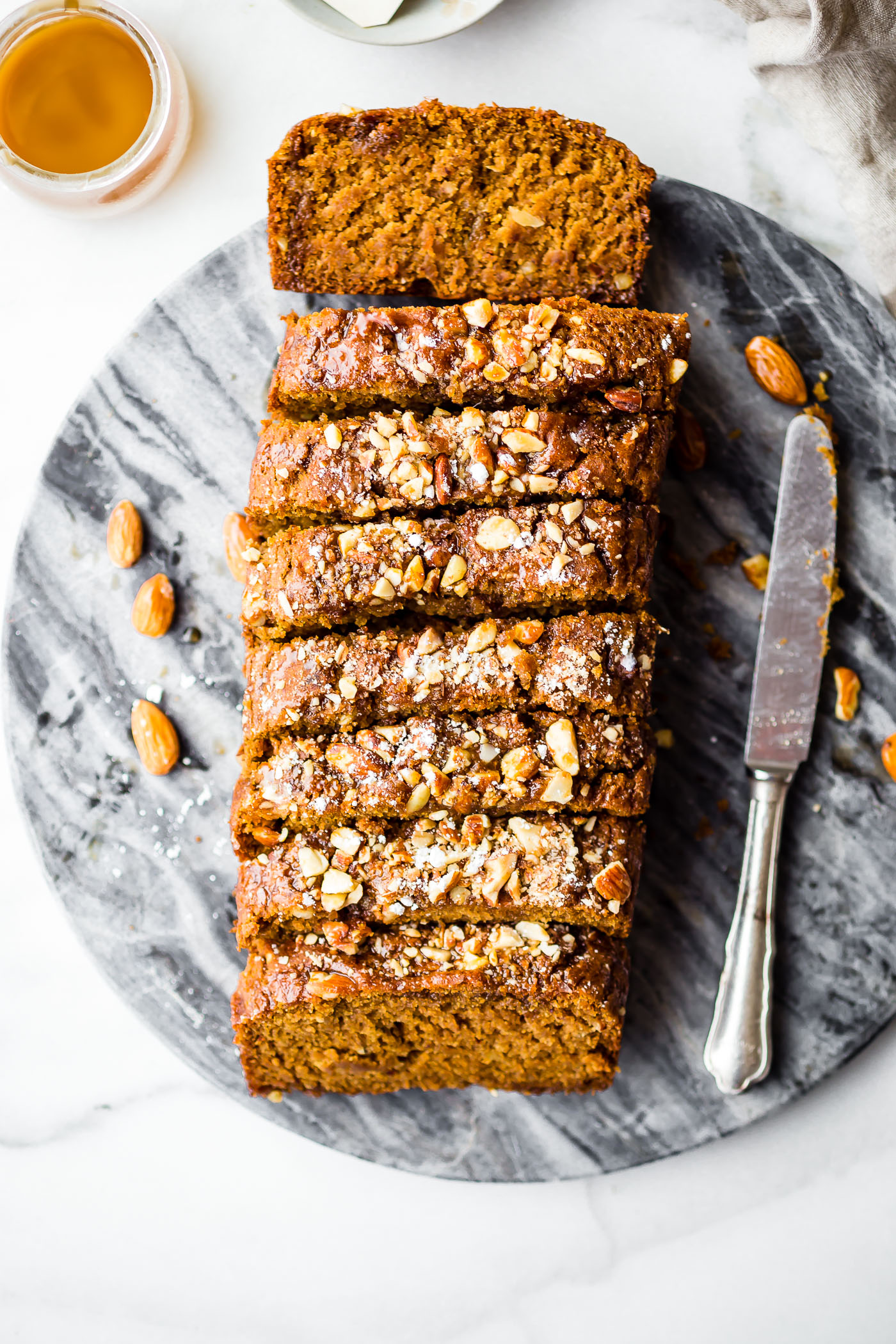 This Vegan Maple Almond Earl Grey Tea cake is lightly sweet and simple. A gluten free buttery tea cake loaf infused with Earl Grey tea and a hint cardamon! The maple almond glaze is the perfect topping. Quick to make in one pan and bakes up in under 45 minutes!
