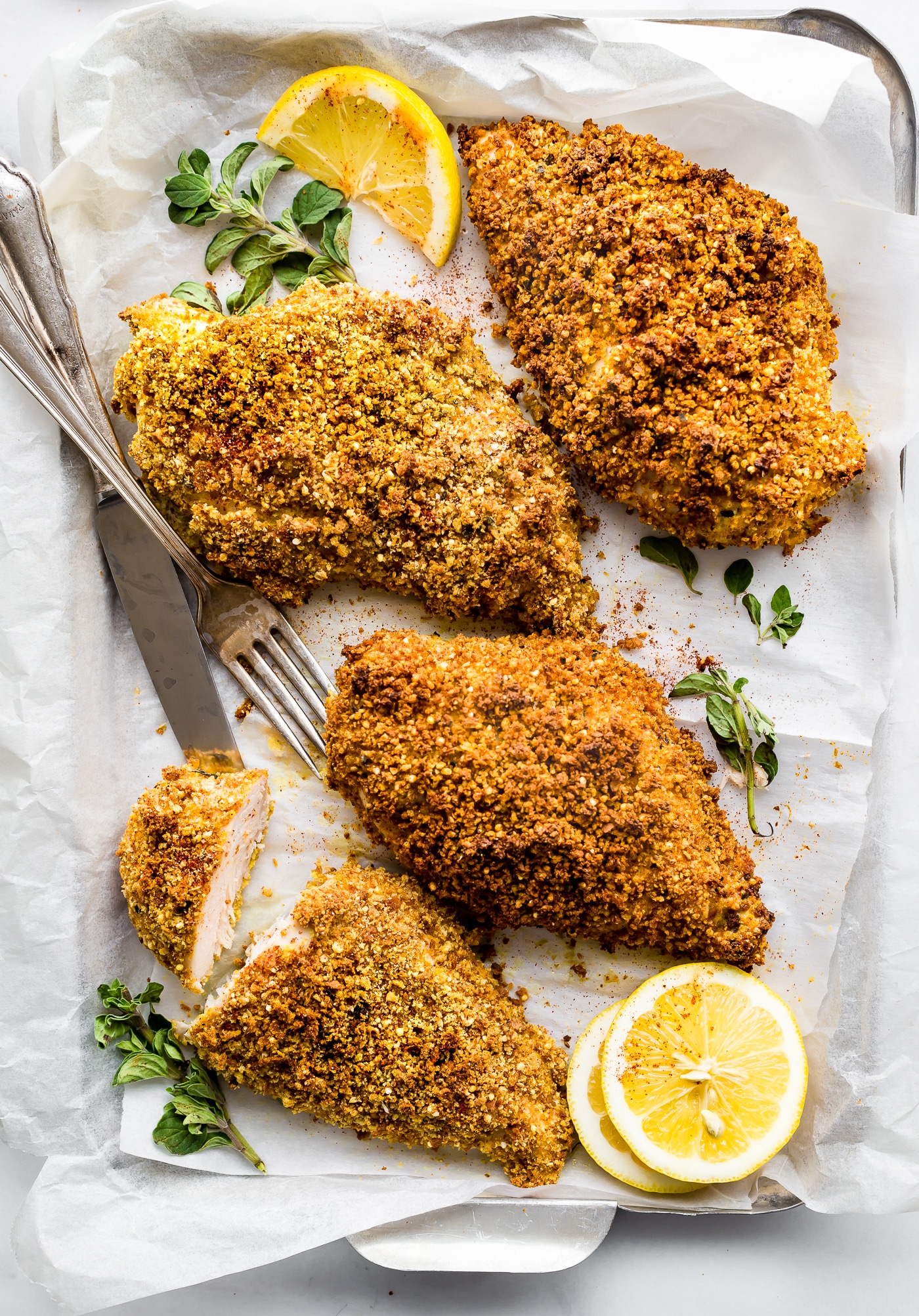 Gluten-Free Panko Crusted Paprika Chicken! This baked crusted chicken recipe is simple to make with gluten-free panko bread crumbs and paprika spices! Bake it with veggies for an easy one pan meal or by itself. Either way, a healthy gluten-free dinner is ready in under 45 minutes! Perfect for entertaining guests or feeding the family.