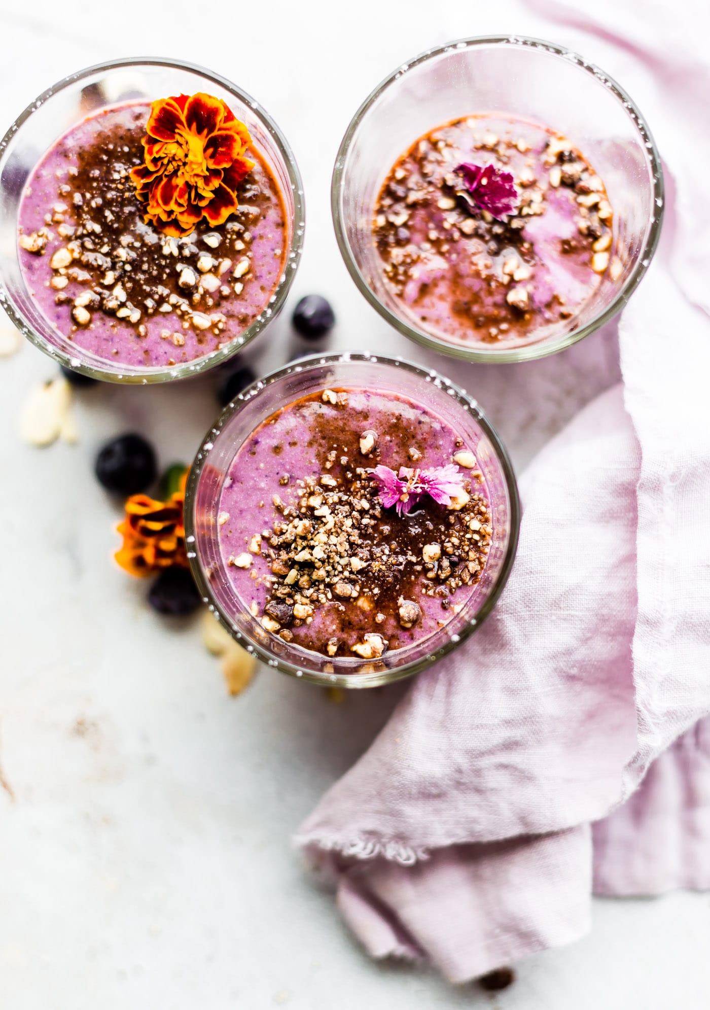 These Almond Berry Mini Cheesecake Smoothies s are packed with real food protein and healthy ingredients. No protein powder needed and Vegan friendly option.  Smoothies make a great healthy breakfast, snack, or dessert.  Berries, almonds, coconut milk, cashew cream or cottage cheese (for the cheesecake part), and a dash of cinnamon make this smoothie recipe filling and wholesome!