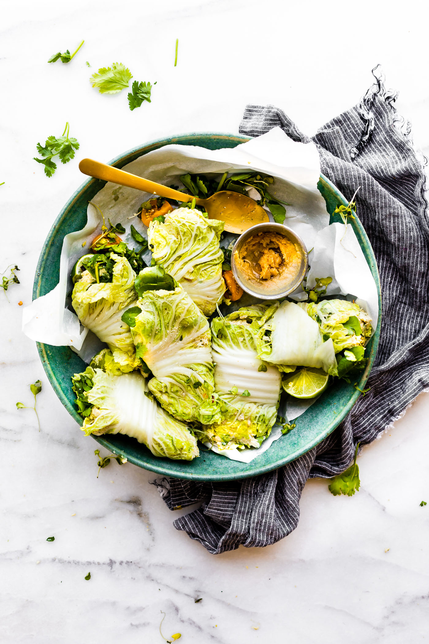 Miso Mango Chicken Salad Cabbage wraps are the perfect light low carb lunch that's easy to make! A mango chicken salad that's mayo free, paleo friendly, and flavorful! Spread the miso mango chicken salad mixture over napa cabbage, add a little bit of watercress, then firmly roll up! Bam, a perfectly handy lunch or light dinner!