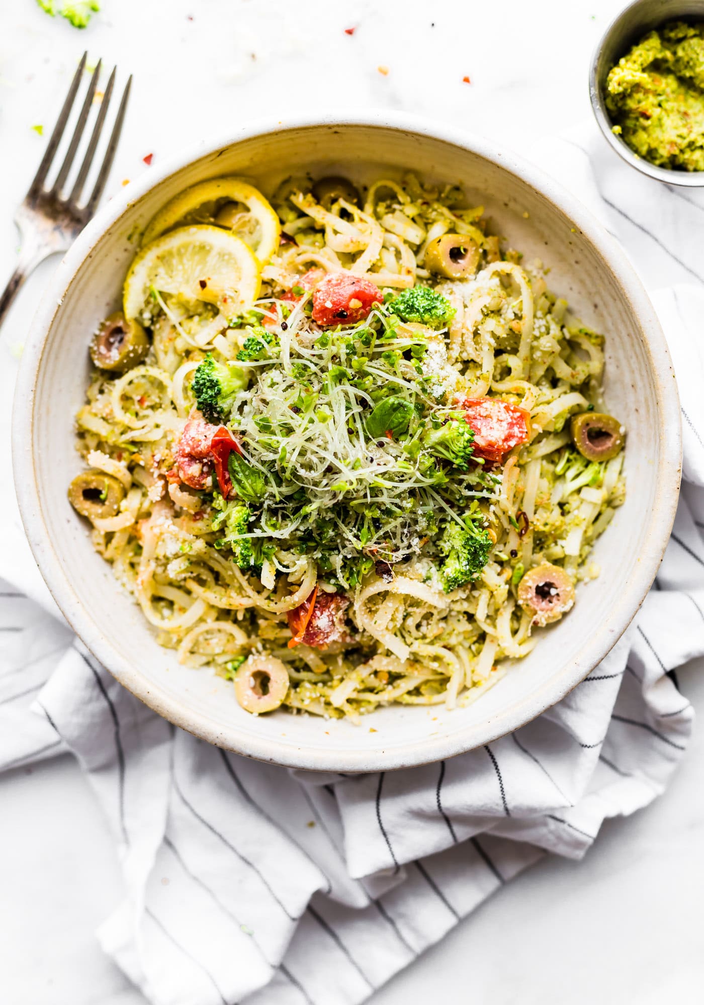This gluten free Peppery Broccoli Arugula Pesto Pasta is gonna rock your world! A pesto pasta with broccoli and arugula and packed with nutrition and flavor! An easy pasta dinner for a quick weeknight dinner or healthy lunch! Ready in under 30 minutes and vegan friendly option. www.cottercrunch.com