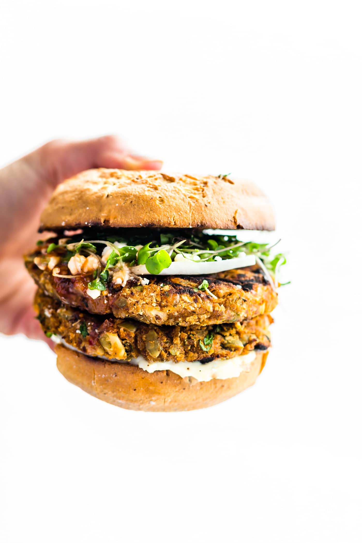 Grilled Moroccan Cauliflower Chickpea Burgers! Flavorful veggie-packed chickpea burgers made with plant based ingredients and served on gluten free hamburger buns! This is one killer gluten free veggie burger recipe you can make on the grill or in the oven! Moroccan spices mixed with cauliflower and chickpeas make these burgers to die for! Delicious, simple, healthy, and easy!