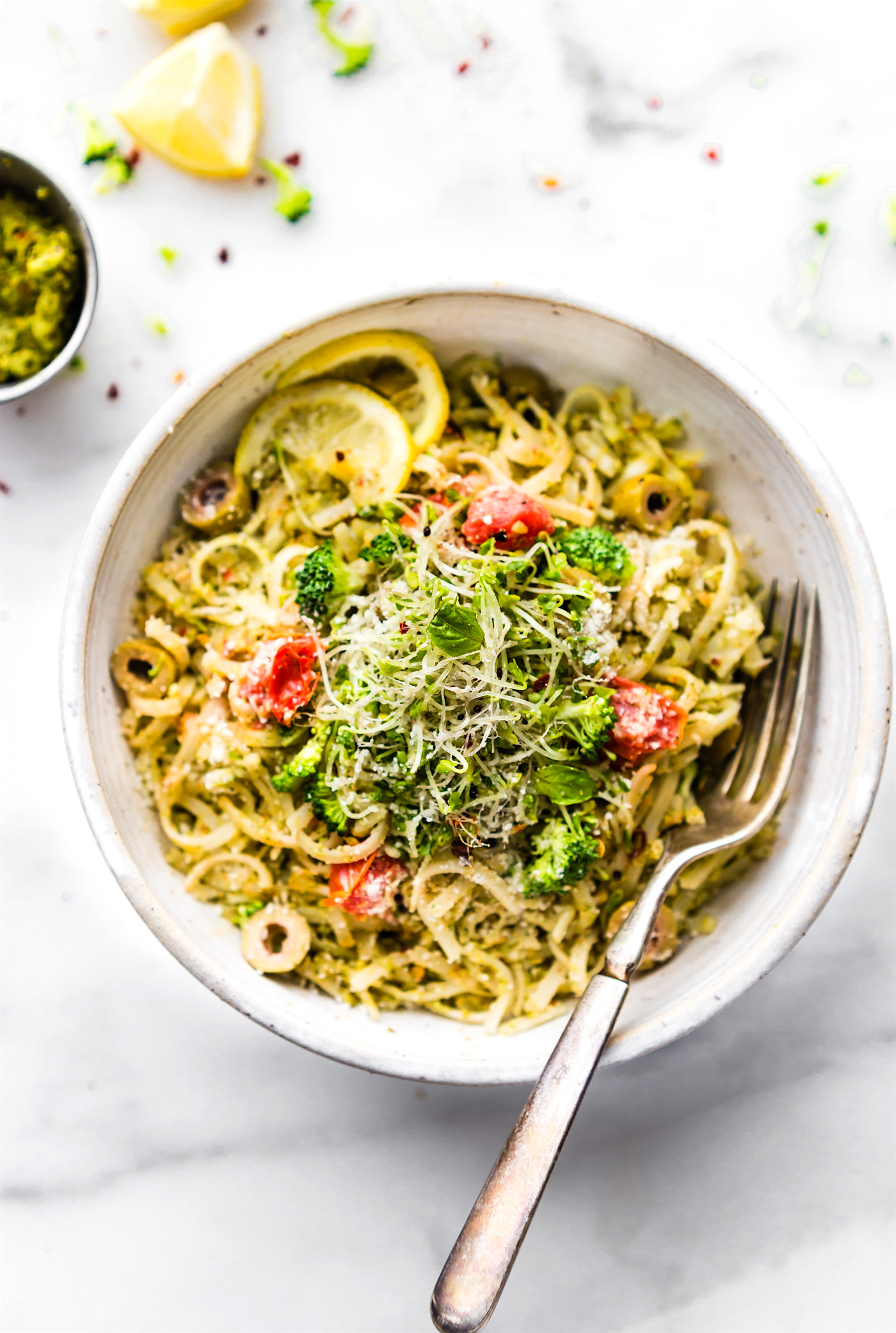bowl full of spring pesto pasta made with arugula and broccoli