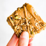 A maple sesame quinoa bar drizzled with sunflower seed. butter