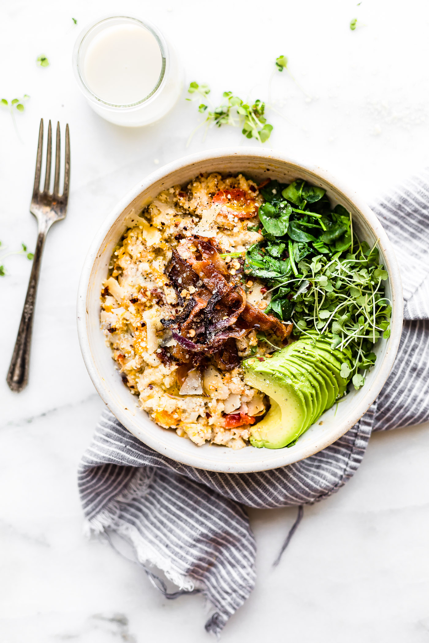 This Savory slow cooker oatmeal with crispy bacon will make you jump out of bed! A savory spin to your regular sweet oatmeal and total crowd pleaser dish, which is perfect for busy mornings! A Slow cooker oatmeal made with the addition butternut squash, garlic, herbs, parmesan cheese, and topped with crispy bacon and avocado. An easy to make well-rounded healthy meal for any time of day. Dairy free option