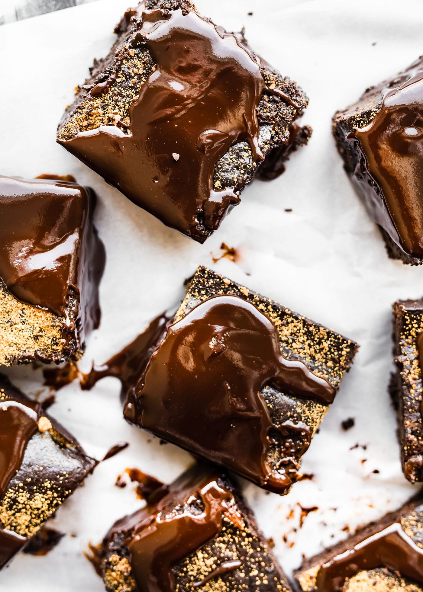 Dirty Chai Dark Chocolate Flourless Brownie squares coated with dark chocolate on parchment