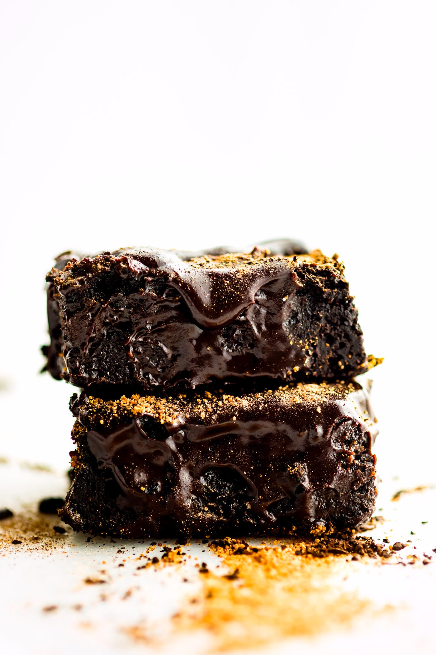 Several dirty chai dark chocolate flourless brownie squares stacked up on each other