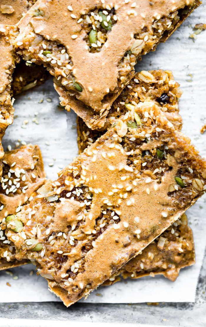 Maple sesame quinoa bars cut into rectangles, stacked on each other.