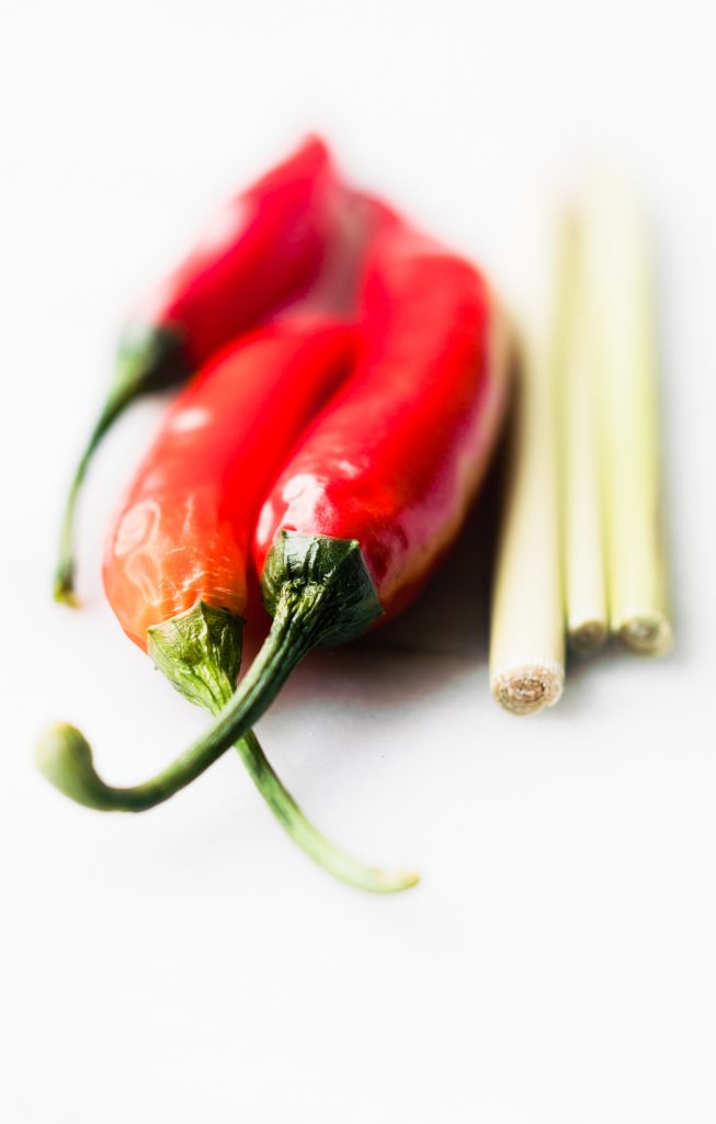Thai peppers and lemon grass on white background