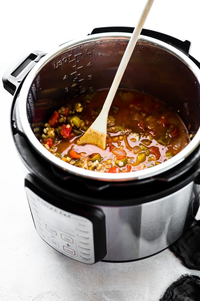 Soup in an instant pot with wooden spoon.