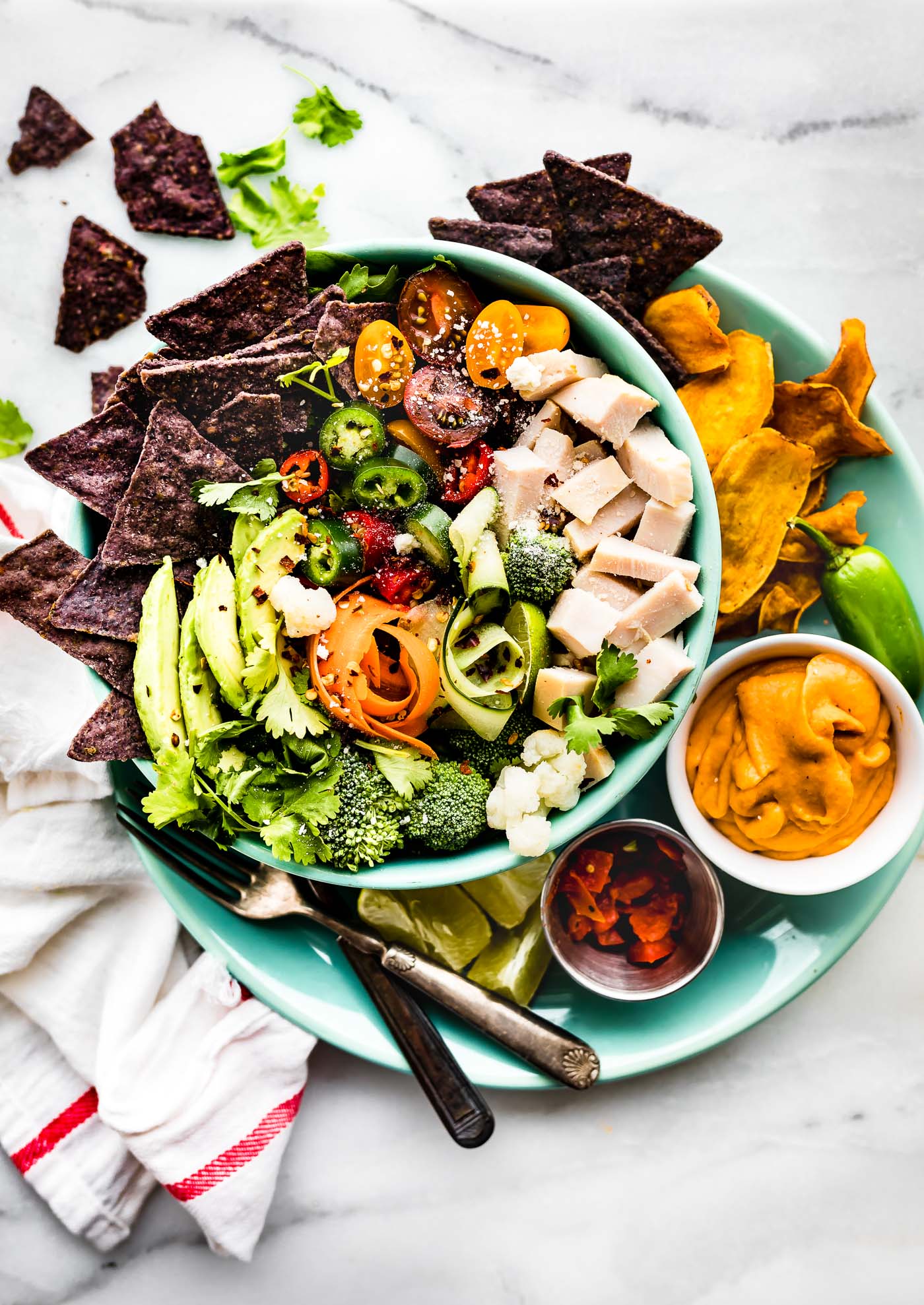Healthy Leftover Turkey Nachos Salad Bowls! Utilize leftover turkey and vegetables with these quick and wholesome loaded salad bowls! Dairy free friendly.
