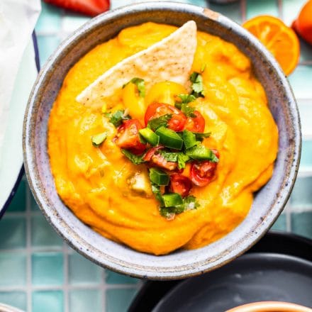 vegan queso + chip in a bowl