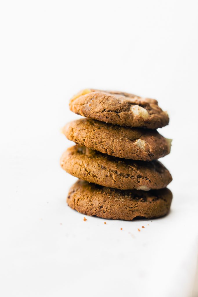 Flourless Candied Ginger Molasses Cookies stacked up on each other. 