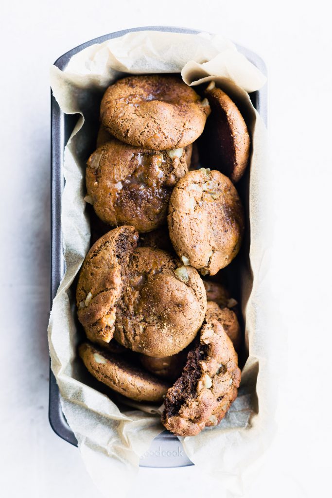 Overhead view flourless chewy candied ginger molasses cookies in parchment-lined loaf pan.