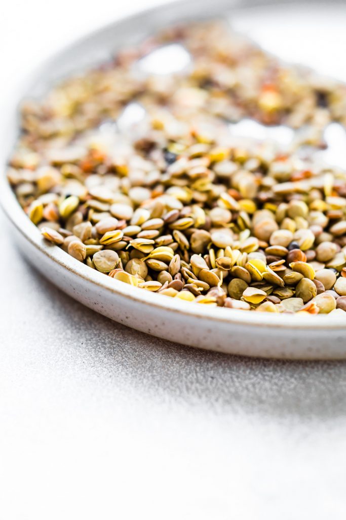 Macro view lentils in low profile stone bowl.