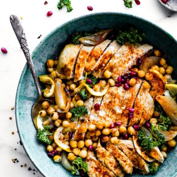 Overhead view cumin roasted chickpea chicken bowls with greens in turquoise bowl