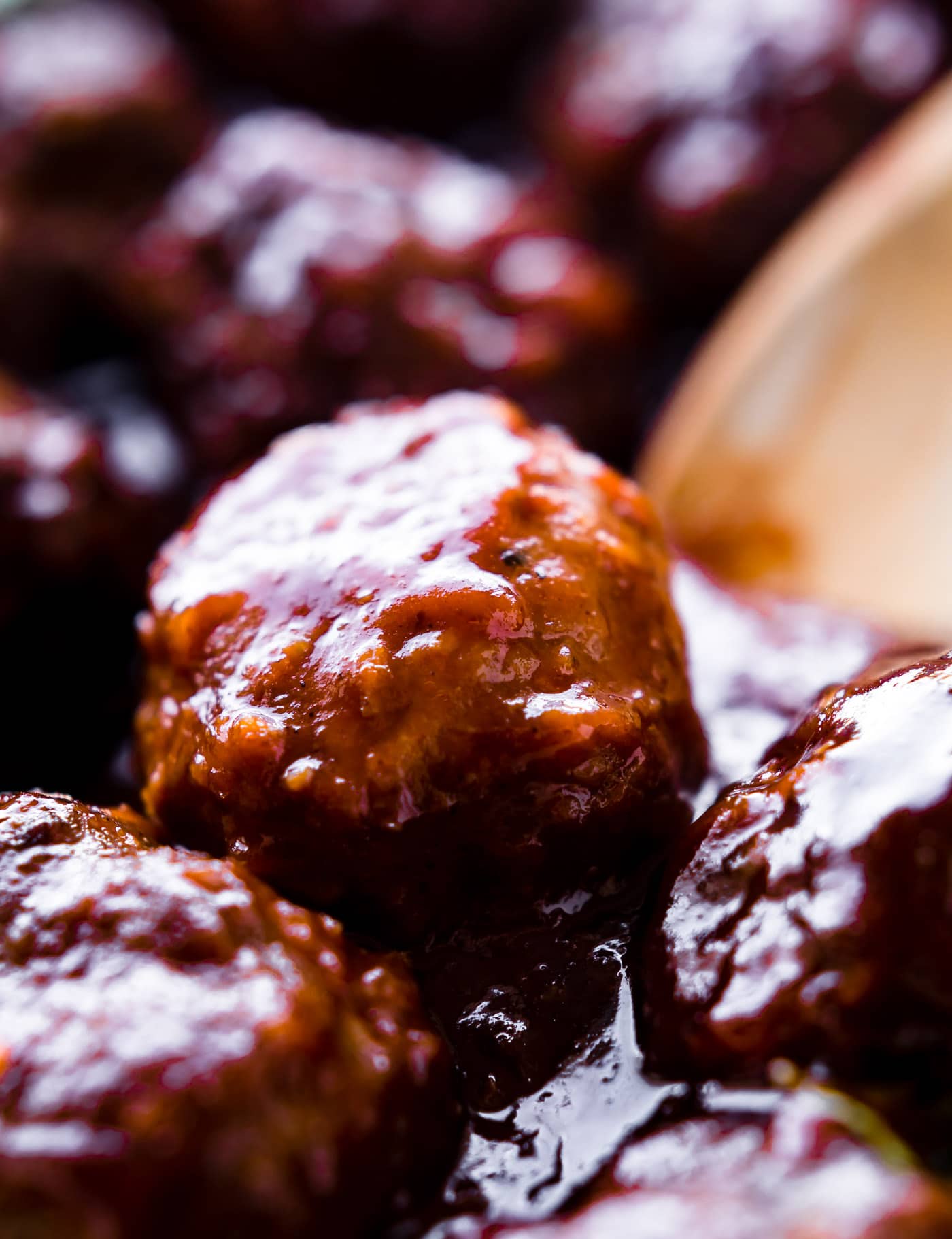 Close up side view meatballs coated in bbq sauce