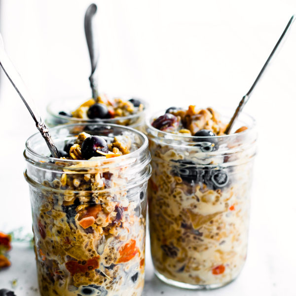 superood instatn pot oatmeal in mason jars topped with berries and served with spoons sticking out of the top