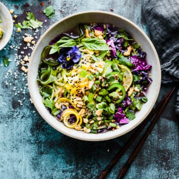 Overhead view stone bowl filled with Asian-Inspired Zoodle Flu Buster Soup