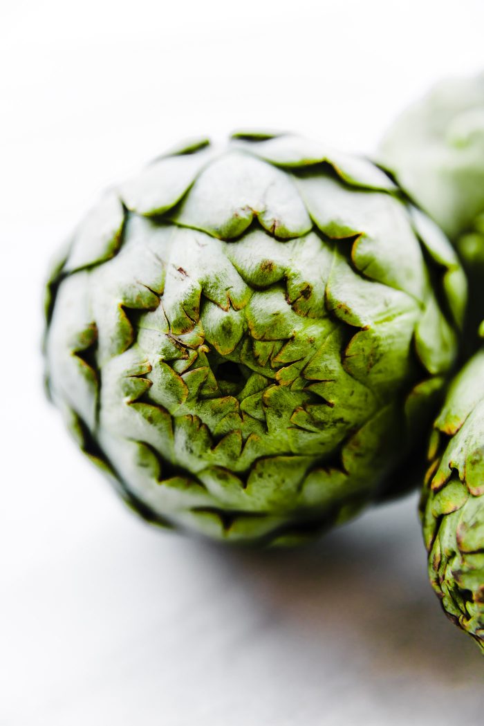 Close up of artichoke, the top of the artichoke uncooked.