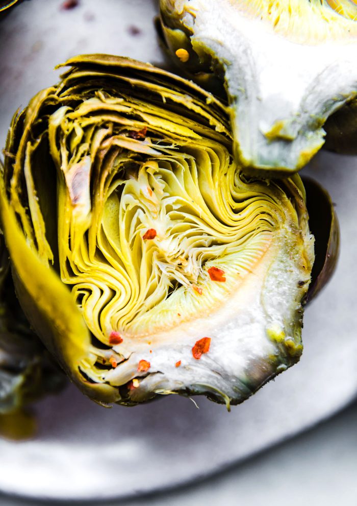 Half a cooked Instant Pot artichoke with the center exposed.