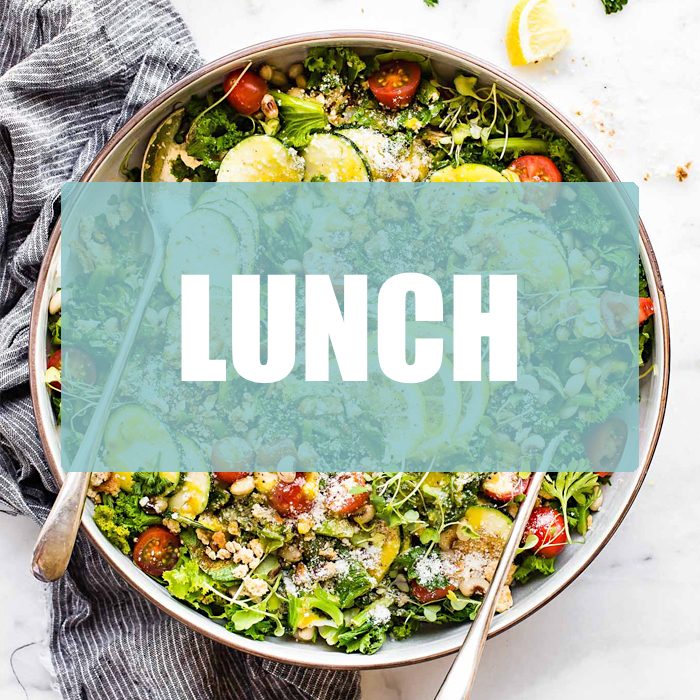 Overhead view salad bowl with fresh vegetables in stone bowl with text overlay for 'lunch'