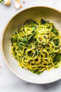 a bowl of low carb and gluten free roasted poblano pesto zoodles