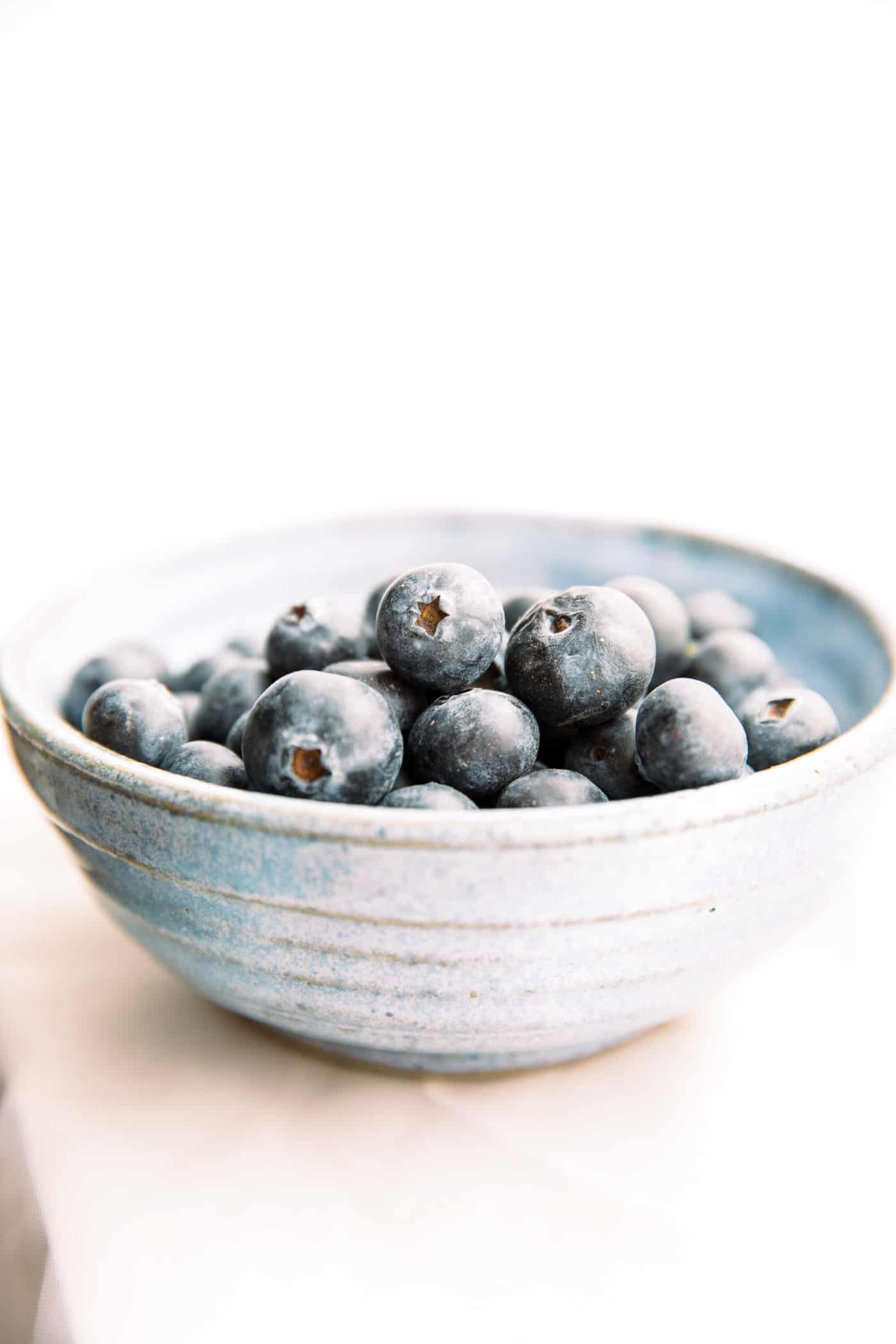 Fresh blueberries in stone bowl.