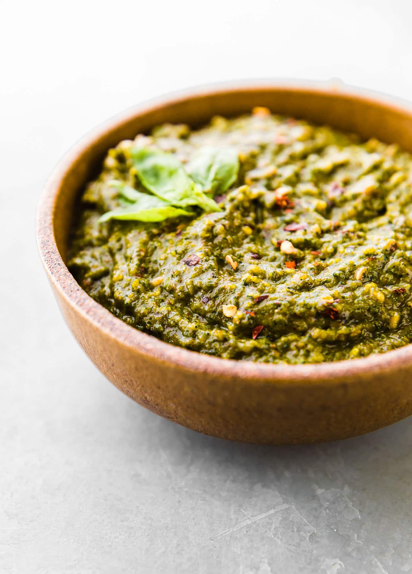 Side view of Asian Basil Pesto Sauce in stone bowl