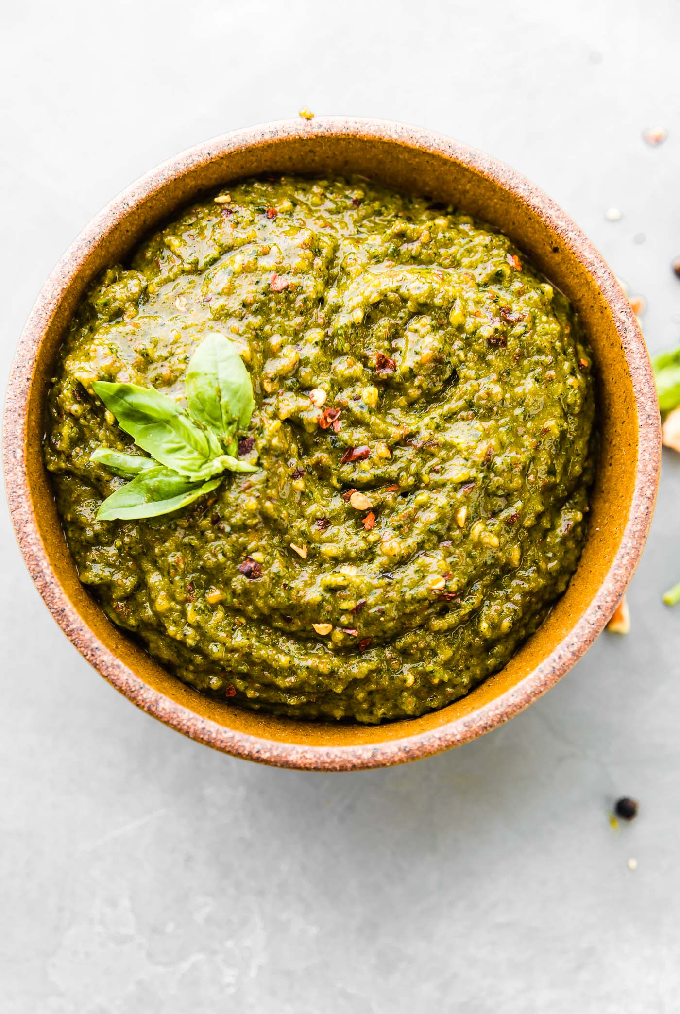 asian pesto in stone bowl with fresh basil on top.