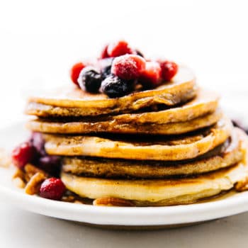 stack of coconut flour pancakes topped with fresh berries