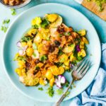 baked salmon with peach salsa on blue plate with fork