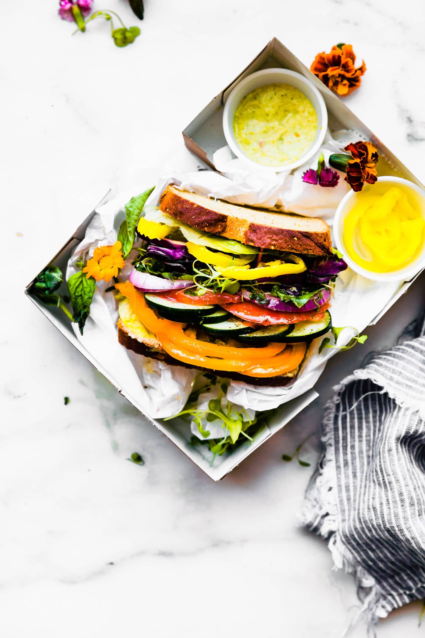 Overhead view lunch box with extra thick vegetable sandwich made with gluten free bread