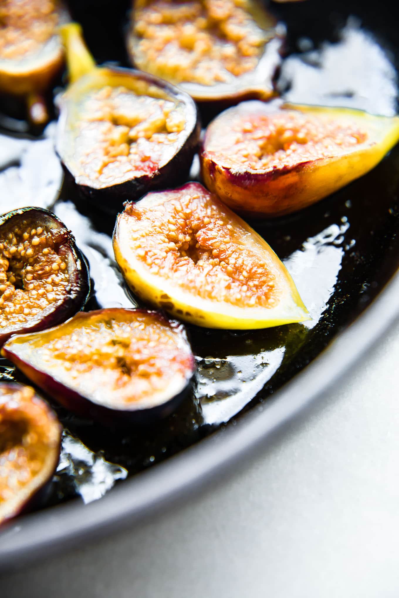 Honey roasted figs cut in half on baking sheet.