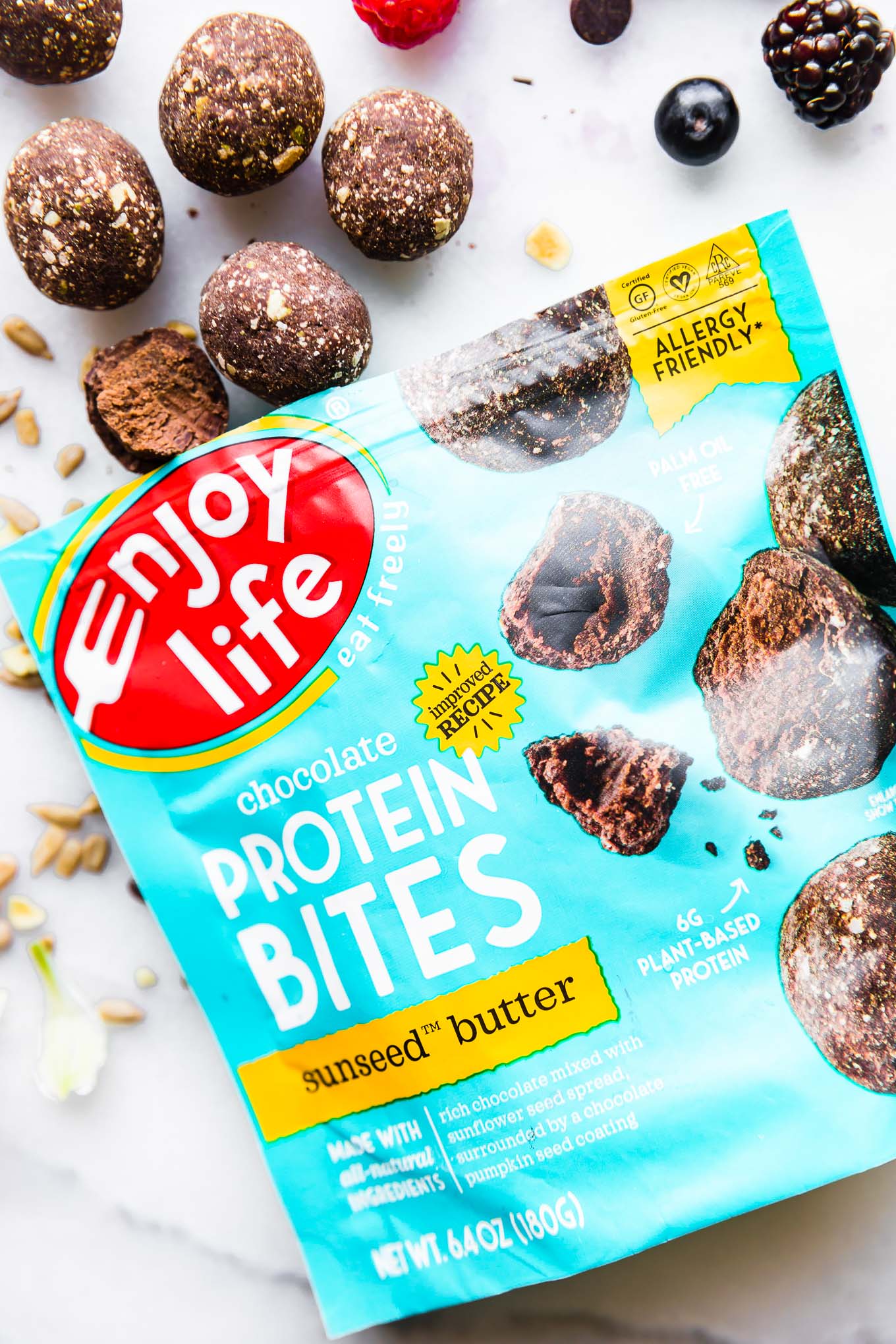 Enjoy Life brand protein bites bag with a few bites out of bag on counter.