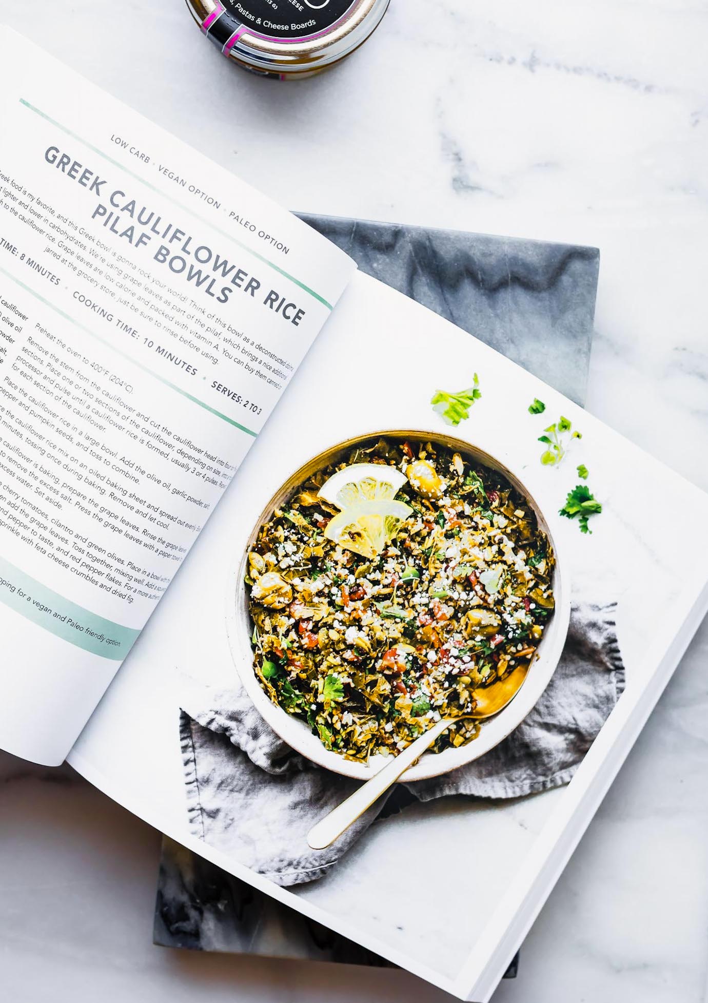 nourishing bowls cookbook open to the page with image of Greek Cauliflower Rice Pilaf Bowls.
